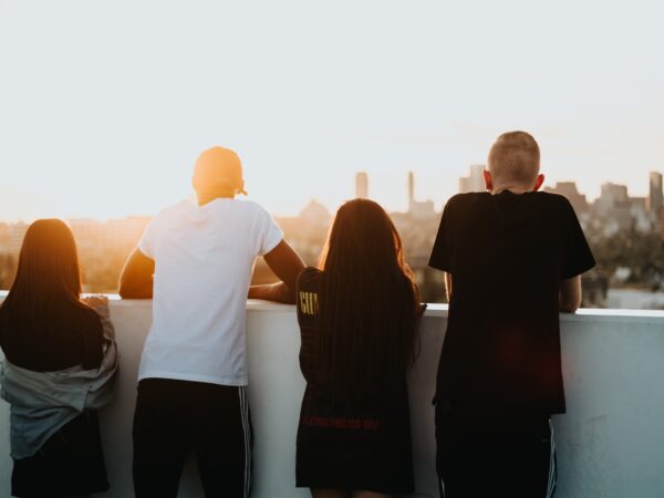 Young people looking across a city skyline