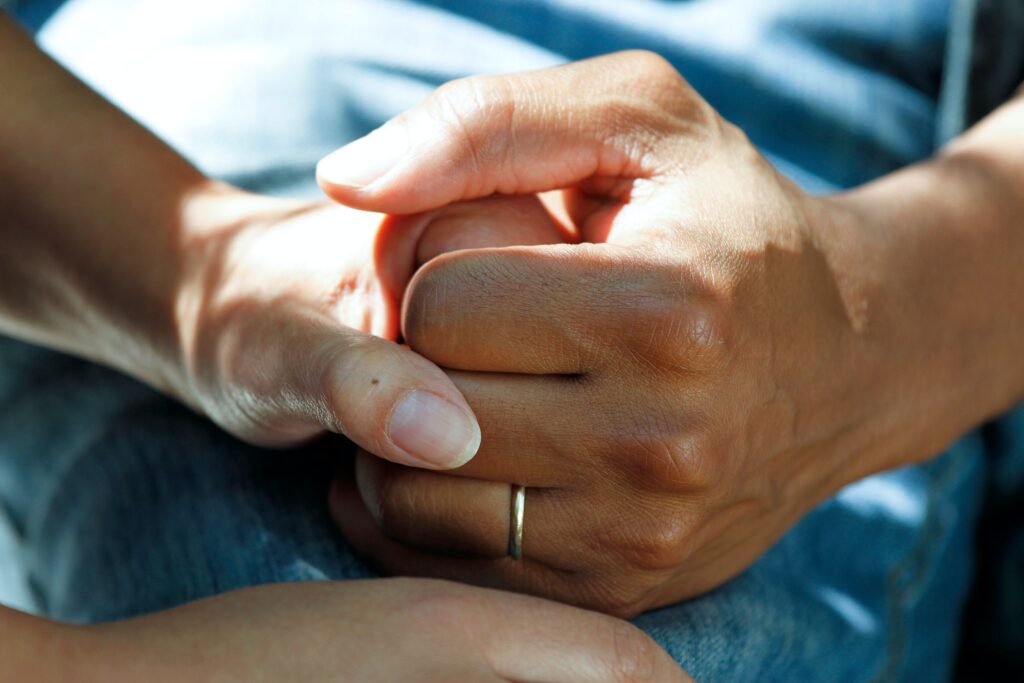 two people holding hands to show care for one another