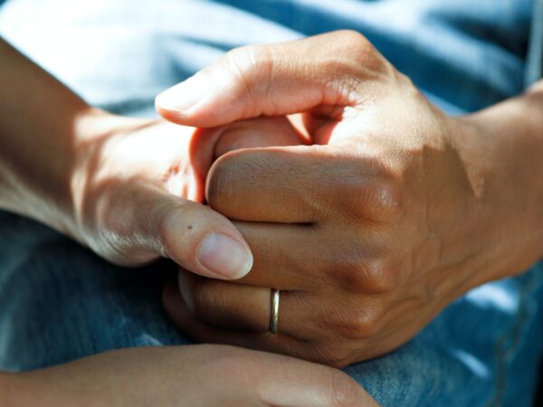 two people holding hands to show care for one another
